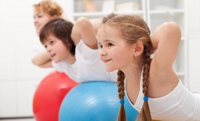 Kids and woman doing exercises with balls Kids and woman doing exercises with balls